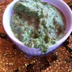 Creamy spinach and artichoke dip served with flax crackers