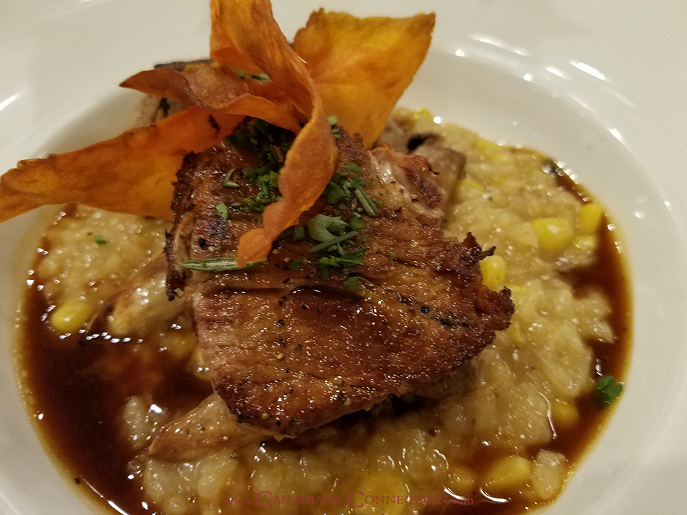 Picture of braised pork shoulder, roasted mushrooms, and corn risotto with smoked pork lime broth from Blue Poppy Restaurant