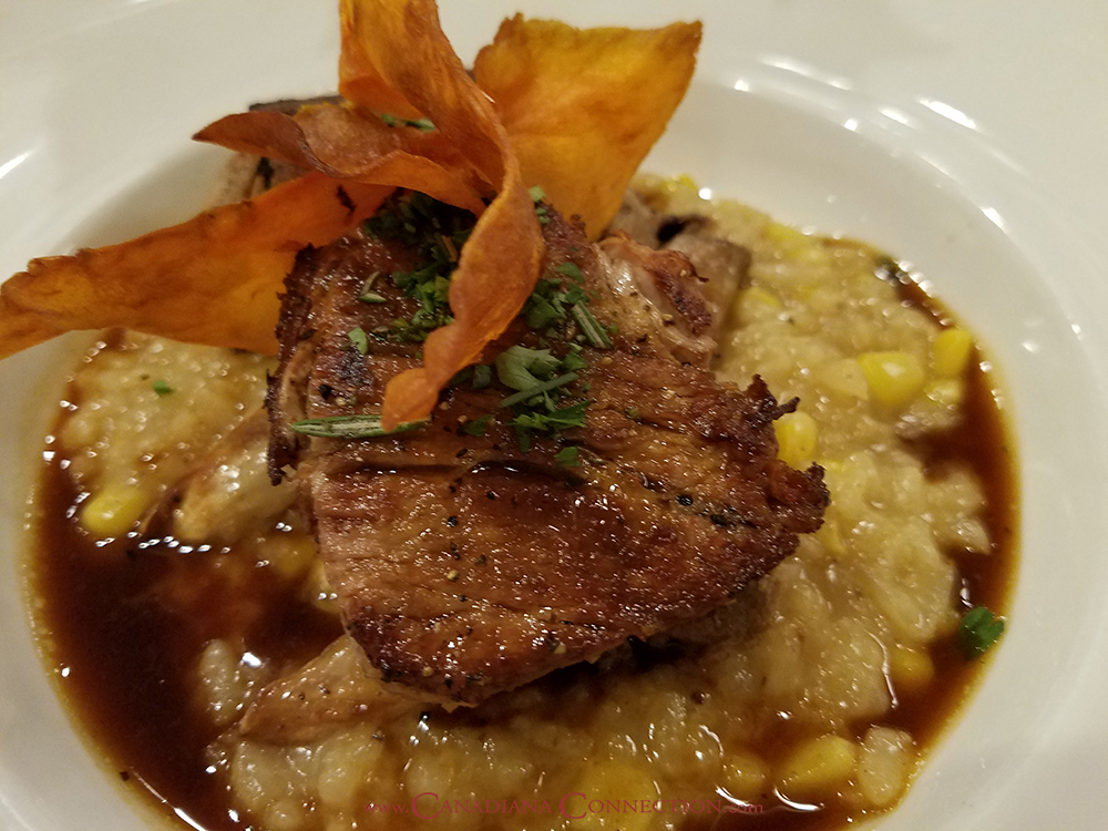 Picture of braised pork shoulder roasted mushrooms and corn risotto with smoked pork lime broth from blue poppy restaurant