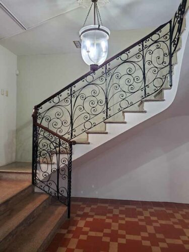 Fancy ironwork down the stairs to the kitchen